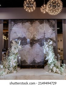 Beautiful wedding scenery photo area in white with gypsophila and orchid on a marble background