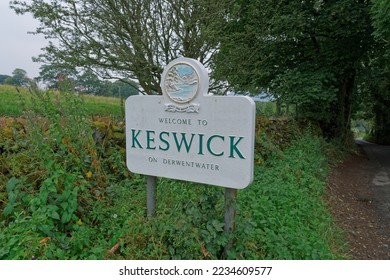 A beautiful welcome to Keswick on Derwentwater sign with the Latin phrase Montes Unde Auxilium Meum ‘The mountains, whence my help' on a country lane in Keswick the Lake District England UK - Shutterstock ID 2234609577