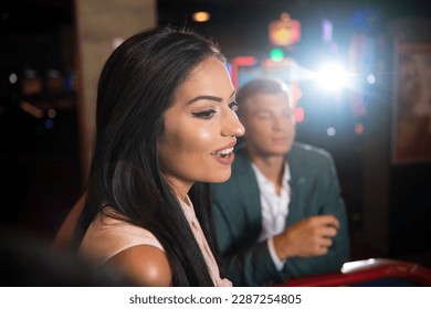 Beautiful and Well Dressed Couple Playing Roulette in the Casino
