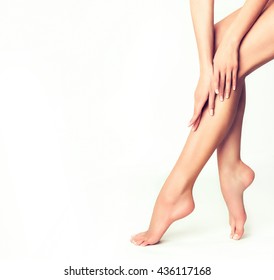 Beautiful well-groomed female legs . Foot care . Depilation of hair on the feet .
