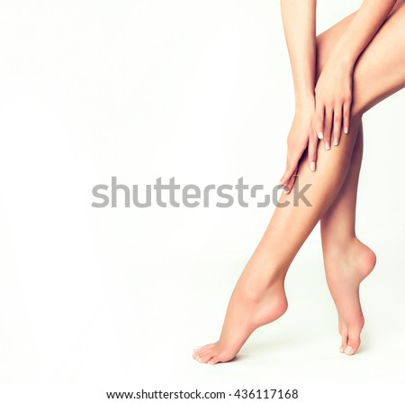 Beautiful well-groomed female legs . Foot care . Depilation of hair on the feet .
