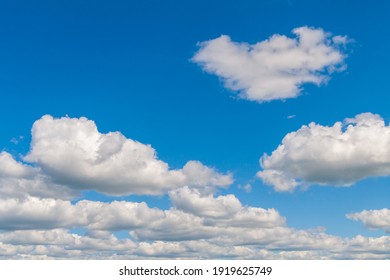 Beautiful whimsical clouds against the blue daytime sky.