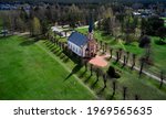 Beautiful white Catholic Church in Latvia ,Aglona, nice blue sky and white clouds. Green grass and trees.