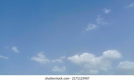 Beautiful White Clouds On Deep Blue Sky Background. Elegant Blue Sky Picture In Daylight. Tiny Small Soft White Clouds In The Blue Sky Background. Cumulus Clouds In Clear Blue Sky. No Focus