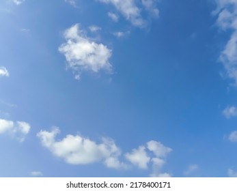 Beautiful White Clouds On Deep Blue Sky Background. Elegant Blue Sky Picture In Daylight. Tiny Small Soft White Clouds In The Blue Sky Background. Cumulus Clouds In Clear Blue Sky. No Focus