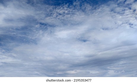 Beautiful White Clouds On Deep Blue Sky Background. Elegant Blue Sky Picture In Daylight. Large Bright Soft Fluffy Clouds Are Cover The Entire Blue Sky. Cumulus Clouds Against Blue Sky. No Focus