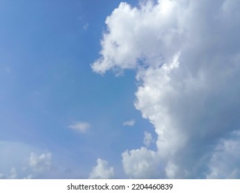 Beautiful White Clouds On Deep Blue Sky Background. Elegant Blue Sky Picture In Daylight. Tiny Small Soft White Clouds In The Blue Sky Background. Cumulus Clouds In Clear Blue Sky. No Focus