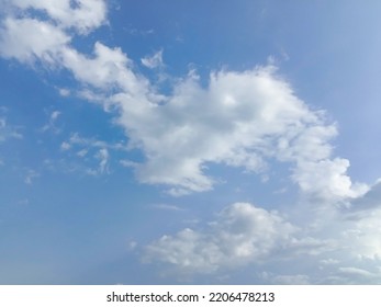 Beautiful White Clouds On Deep Blue Sky Background. Elegant Blue Sky Picture In Daylight. Tiny Small Soft White Clouds In The Blue Sky Background. Cumulus Clouds In Clear Blue Sky. No Focus