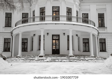 The Beautiful White Facade Of An Old Manor House. Snowy Winter Day. Ancient Architecture. Windows And Door.