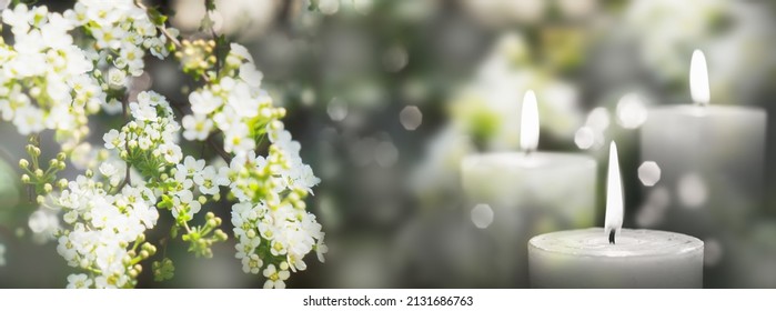 beautiful white flowering branch and 3 white candle lights outside in a garden, floral concept with burning candles decoration for contemplative athmosphere background - Shutterstock ID 2131686763