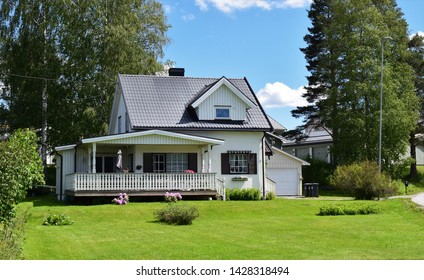 Beautiful White House With Triangular Roof And Gray Tiles - Home With Green Garden In Sunny And Summer Season - Wonderful Estate - Norway/Norwegian (16th June 2019)