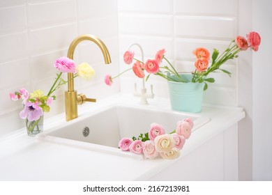 Beautiful White Kitchen Sink With Pink Fresh Flowers And Golden Faucet