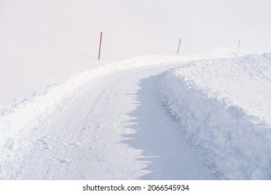 beautiful white landscape, Swiss Alps, wide alpine winter road cleared, large snowdrifts on the side, snowfall in in the city, Sport Concept, Healthy Lifestyle, Winter Activity, travel by car