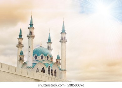 Beautiful white mosque with blue roof against the sky with clouds, sunny. Toned