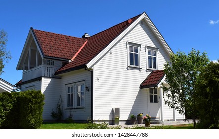 Beautiful White Residence House Exterior With Green Wonderful Garden And Blue Sky Scenery In Sunny And Summer Season - Norway/Norwegian