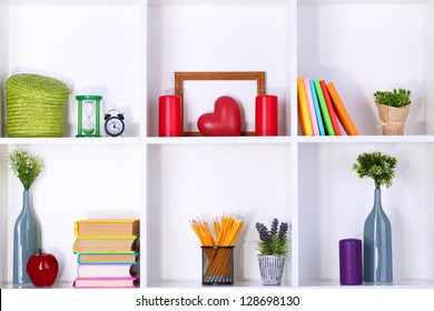 Beautiful white shelves with different home related objects - Powered by Shutterstock