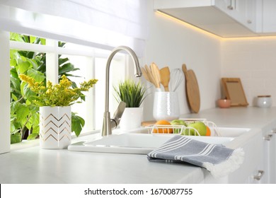 Beautiful white sink near window in modern kitchen - Shutterstock ID 1670087755
