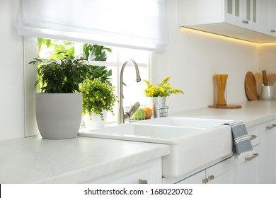 Beautiful white sink near window in modern kitchen - Shutterstock ID 1680220702