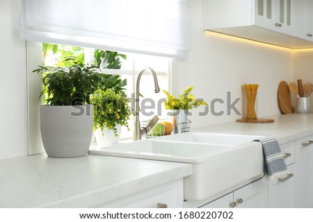 Beautiful white sink near window in modern kitchen