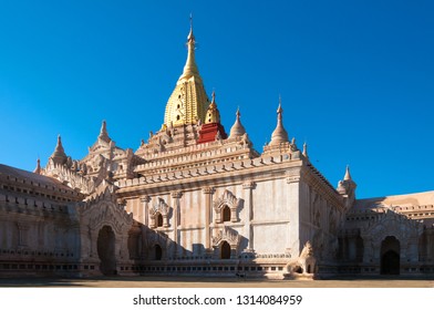 Beautiful white stone Ananda Temple with golden spire at early sunset in Old Bagan in Myanmar with clear blue sky - Powered by Shutterstock