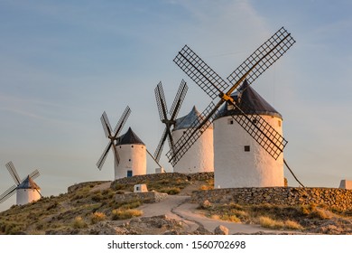 Beautiful white windmill on the hill with blue cloudy sunset sky background