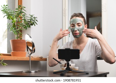 Beautiful White Women Making An Online Course Of Facial Skin Care And Treatment With A Green Clay Mask.