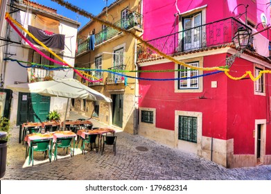 Beautiful wide angle image of the tight streets with lots of colors in Lisbon, Portugal. HDR