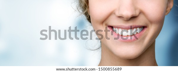 Beautiful wide smile of young\
fresh woman with great healthy white teeth. Isolated over\
background