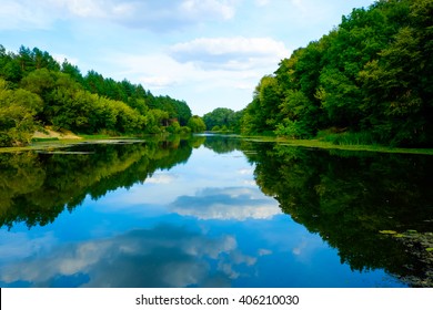 Beautiful wild nature park, forest. River or lake with mirror reflections and clear water on sunny day. Amazing wilderness nature landscape panorama. Quiet river in surroundings greenery in summer. - Powered by Shutterstock