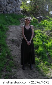 A Beautiful Wild Witch Girl With A Knife Stands By The River Of Water Performs The Ritual Spell Curse, Pagan, Satanist, Magician, God