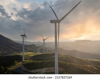 Beautiful wind turbine in the countryside in the time of sunset background. Wind Turbines Windmill Power Farm. Carratraca on the outskirts of Malaga, Spain.