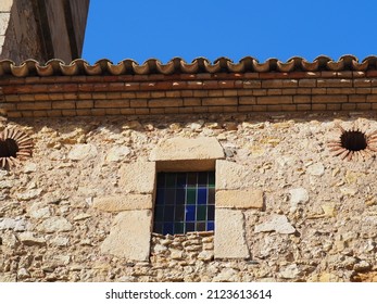 Beautiful Window With Multicolored Glass With An Oculus On Each Side, On The Facade Of The Church Of San Salvador De Vilanova De Prades, Tarragona, Spain, Europe