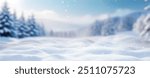 Beautiful winter background of snow and blurred forest in background, Gently falling snow flakes against blue sky. Wide panorama format.