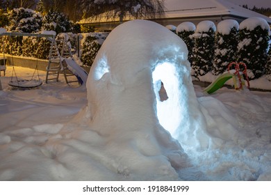 Beautiful Winter Garden With Snow Igloo At Night. Poland