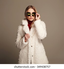 Beautiful Winter Girl In White Fur And Sunglasses. Winter Fashion Beauty Young Woman