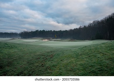 A beautiful winter golf course with early morning frost, calm weather, gray-green colors, soft lines.