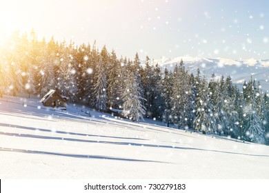 Beautiful winter landscape in the mountains with falling snow and a little house. Happy New Year and Merry Christmas celebration concept. Soft light effect - Shutterstock ID 730279183