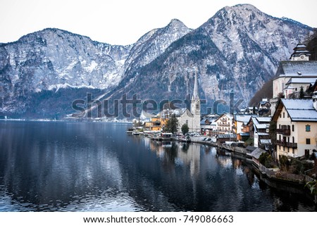 Beautiful Winter landscape and water reflection of historical town by the Lake Hallstatt, Austria, Europe