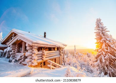 Beautiful Winter Landscape With Wooden Hut And Snow Covered Trees At Sunset In Lapland Finland