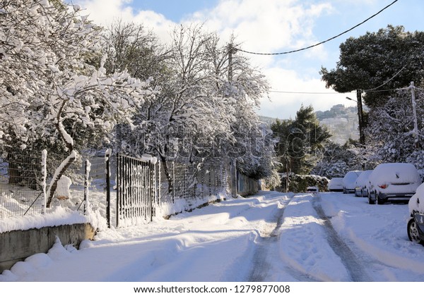 Beautiful winter morning snow\
covered streets of Athens, Greece, 8th of January 2019.\
Horizontal.