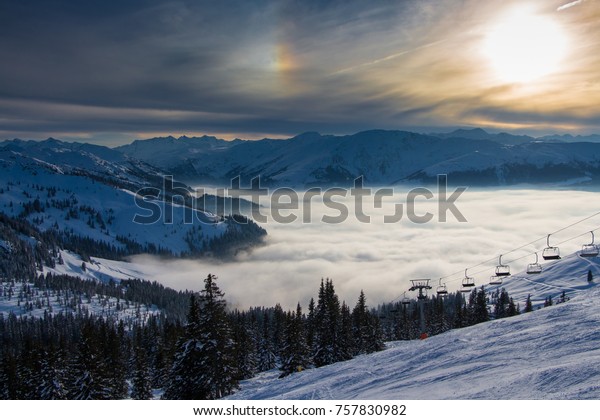 Beautiful winter mountain landscape in the\
Alps, Kitzbuhel ski area, Tyrol , Austria\
Sunset , sea of clouds,\
peaceful evening in the\
mountains.