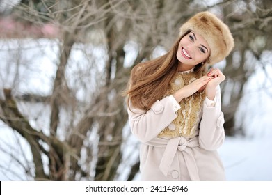 Beautiful winter portrait of young smiling woman outdoor
