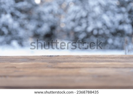 Beautiful winter scene. blurred background of snowy christmas nature background, Wood table top on shiny bokeh. For product display Christmas time mock up 