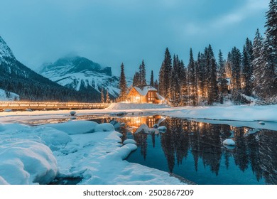 Beautiful winter scene of wooden lodge glowing on Emerald Lake and pine forest at Yoho national park, British Columbia, Canada - Powered by Shutterstock