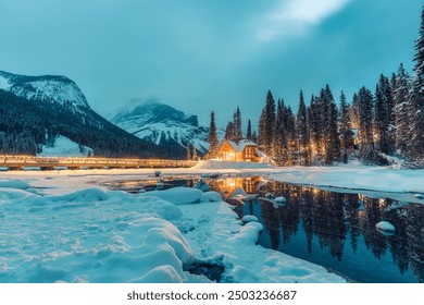 Beautiful winter scene of wooden lodge glowing on Emerald Lake and pine forest at Yoho national park, British Columbia, Canada - Powered by Shutterstock