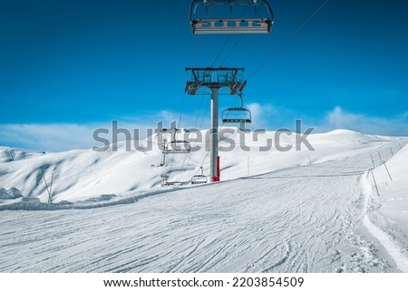 Beautiful winter ski resort with empty ski lifts and ski slopes, La Toussuire, France, Europe