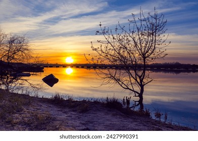 Beautiful winter sunset in the river. Riverscape sunset. Sunset at Tagus River, in the portuguese village of Chamusca - Powered by Shutterstock