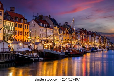 Beautiful winter sunset view of the popular Nyhavn area at Copenhagen, Denmark, decorated for Christmas - Powered by Shutterstock