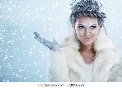 Beautiful winter woman enjoying in snow
