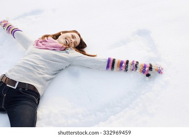 Beautiful Winter Woman Have Fun In Winter Park Lying On Snow